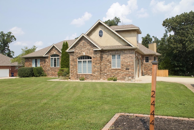 craftsman house featuring brick siding, a chimney, a front lawn, and a shingled roof