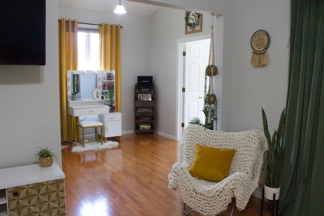 sitting room with hardwood / wood-style flooring