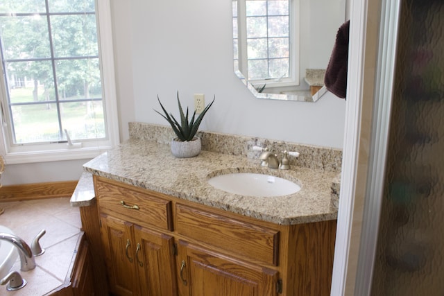 full bath with vanity, a shower stall, and a healthy amount of sunlight