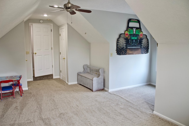 bonus room with baseboards, lofted ceiling, a ceiling fan, and carpet