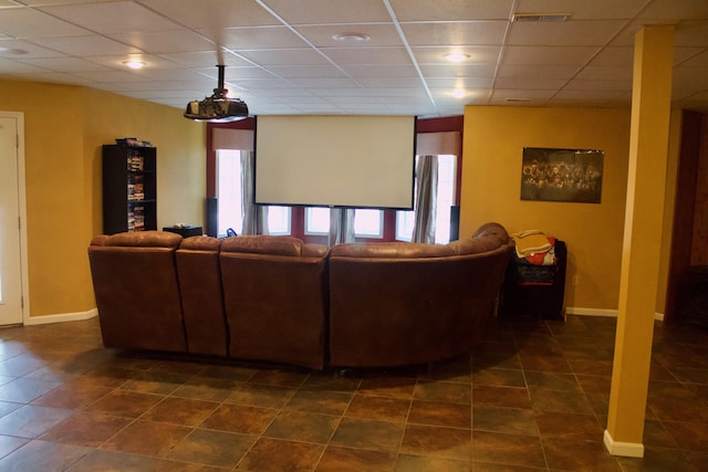 living room with dark tile patterned floors, visible vents, and a paneled ceiling