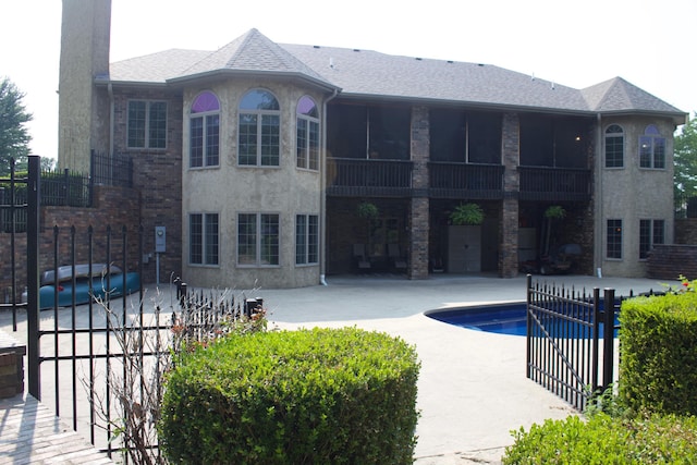view of swimming pool with a patio area, a fenced in pool, and fence