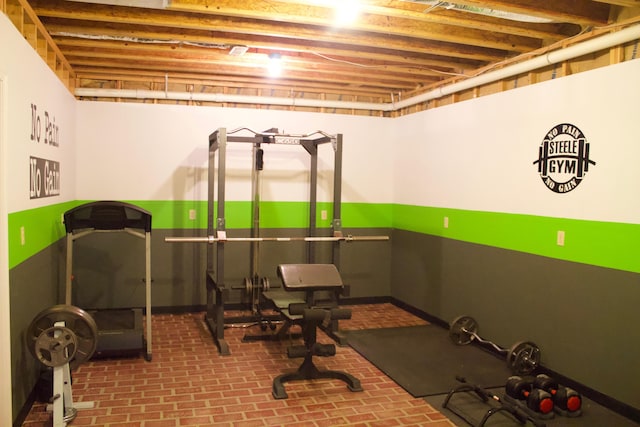 workout area with brick floor