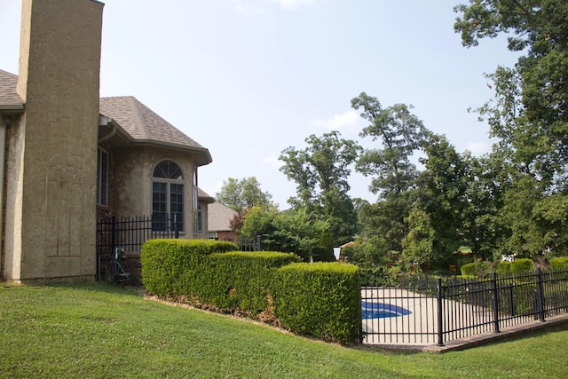 view of yard featuring fence, a fenced in pool, and a patio