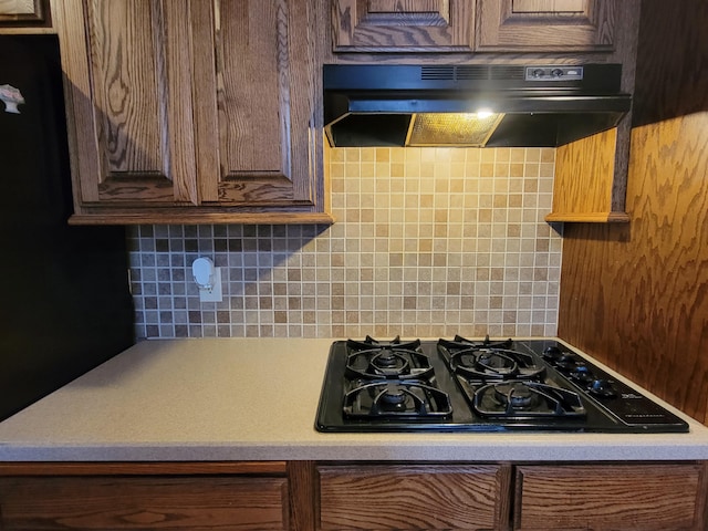 kitchen featuring extractor fan, black gas cooktop, and tasteful backsplash