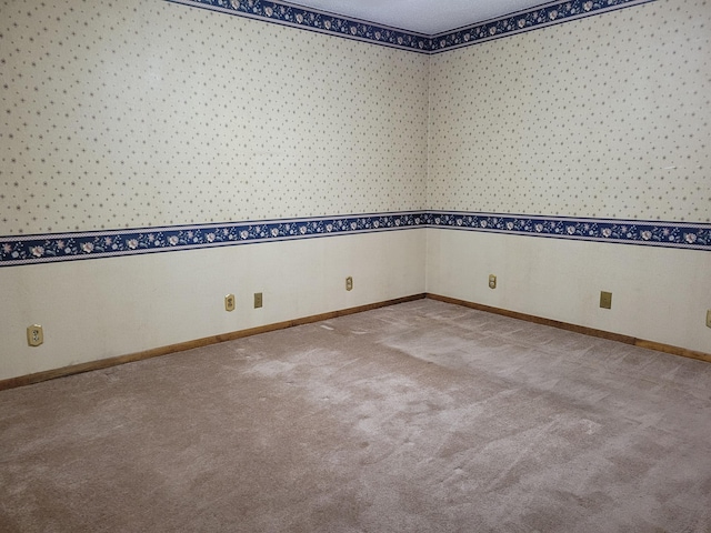 carpeted empty room with a textured ceiling