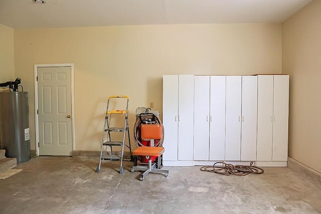 interior space featuring unfinished concrete floors and electric water heater