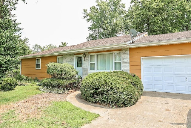 ranch-style home with concrete driveway and a garage