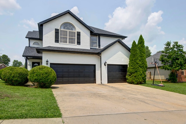 front facade featuring a front yard and a garage