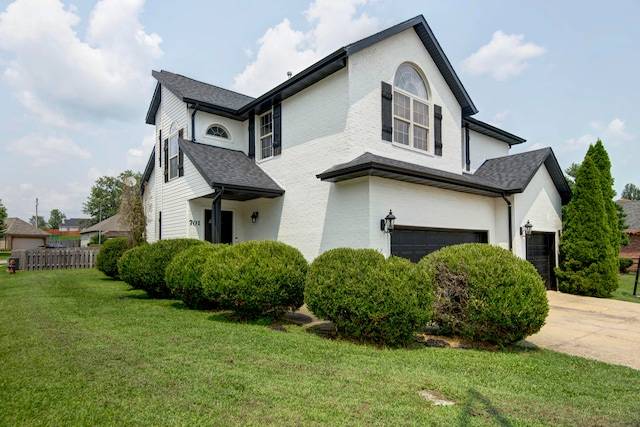 view of front of home featuring a front yard and a garage