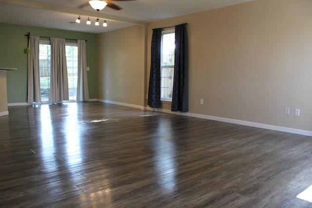 spare room with ceiling fan and dark hardwood / wood-style floors