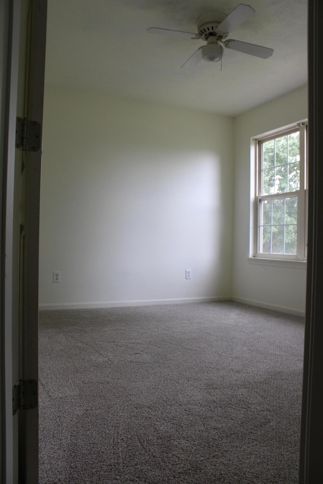 carpeted empty room with ceiling fan