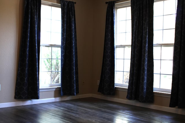 spare room featuring dark hardwood / wood-style floors