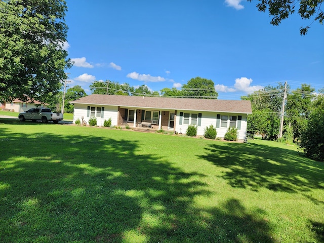 ranch-style home featuring a front lawn