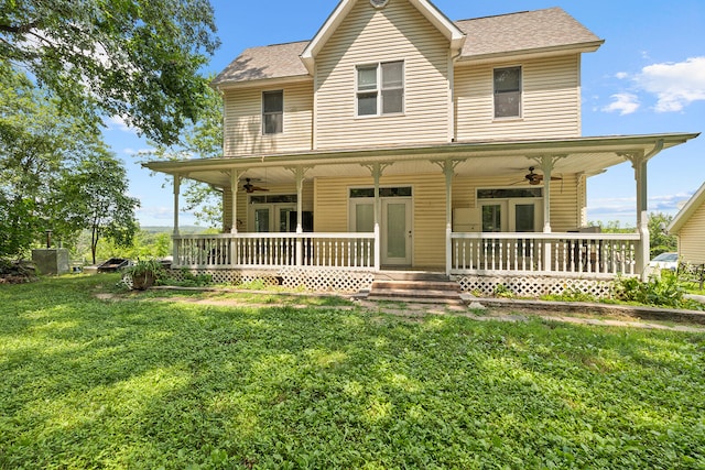 country-style home featuring a front lawn, french doors, ceiling fan, and a porch