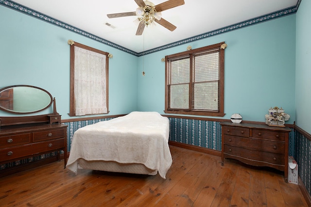 bedroom featuring wood-type flooring and ceiling fan