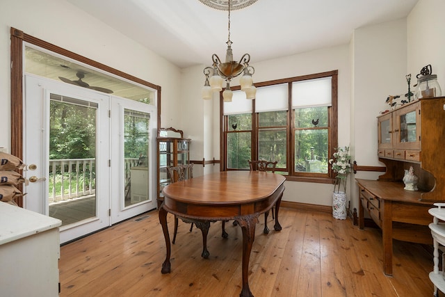 dining area featuring an inviting chandelier and light hardwood / wood-style floors