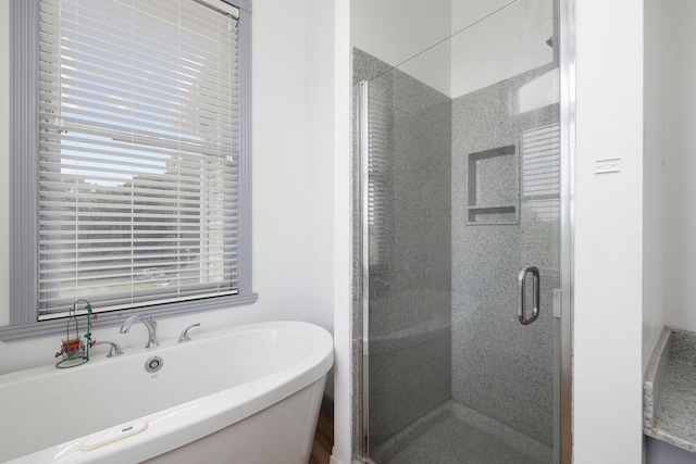 bathroom featuring separate shower and tub