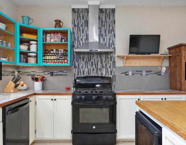 kitchen featuring white cabinets, black gas stove, wall chimney exhaust hood, dishwasher, and decorative backsplash