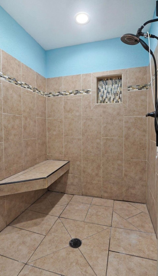 bathroom with tile patterned floors and tiled shower