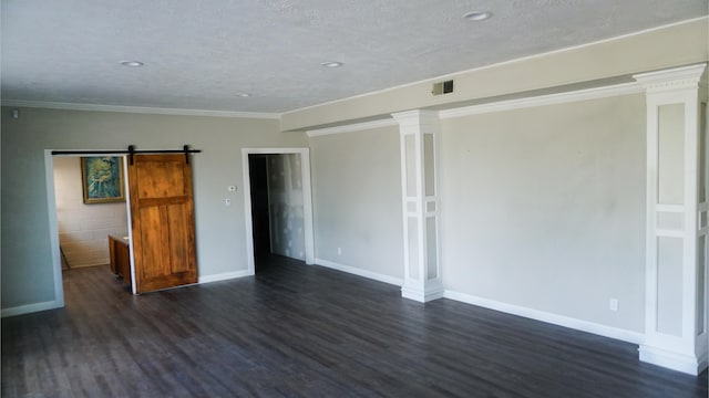 spare room with a barn door, crown molding, dark hardwood / wood-style flooring, and a textured ceiling