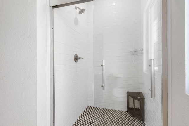 full bath with a textured wall and a stall shower