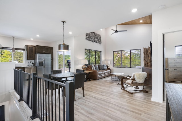 interior space featuring a high ceiling, recessed lighting, a ceiling fan, and light wood-style floors