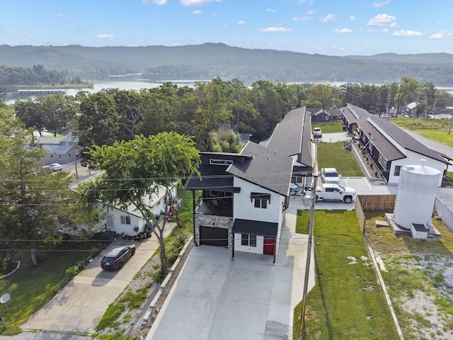 birds eye view of property featuring a water and mountain view and a residential view