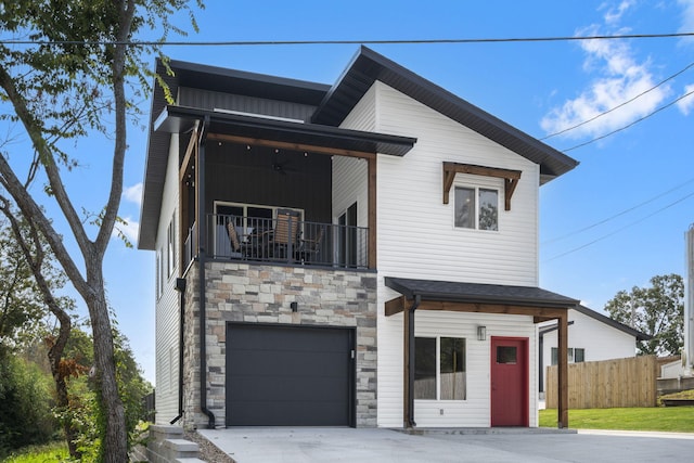 contemporary house with board and batten siding, fence, a balcony, a garage, and stone siding