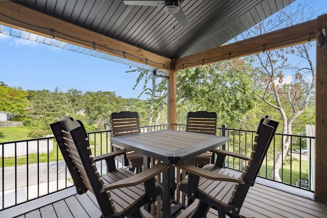 wooden terrace with ceiling fan and outdoor dining area