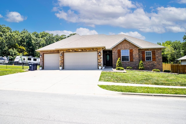 view of front of property featuring a front yard and a garage