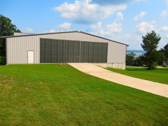 view of pole building with a lawn