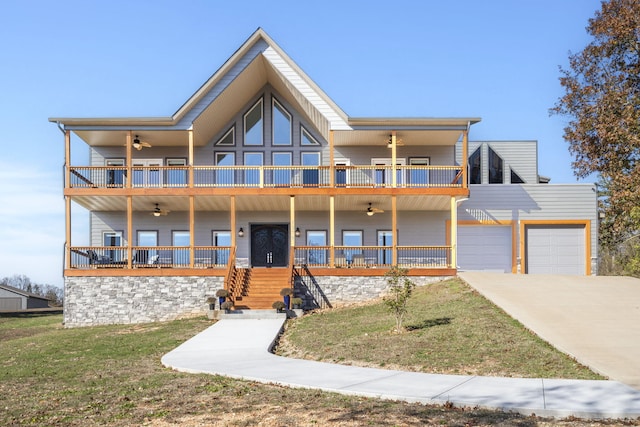 view of front of home featuring a balcony, a front yard, a porch, and a garage