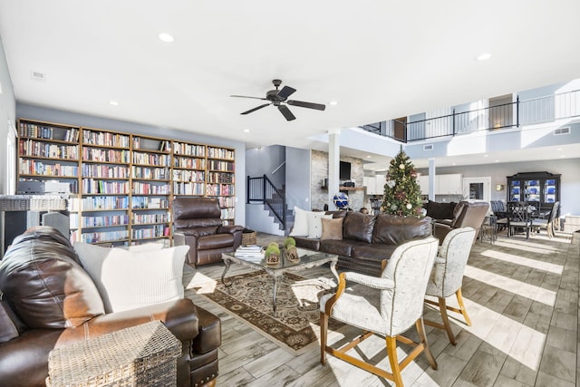 living room with ceiling fan and light wood-type flooring