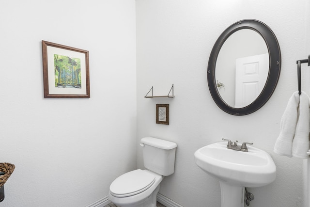 bathroom featuring toilet and sink