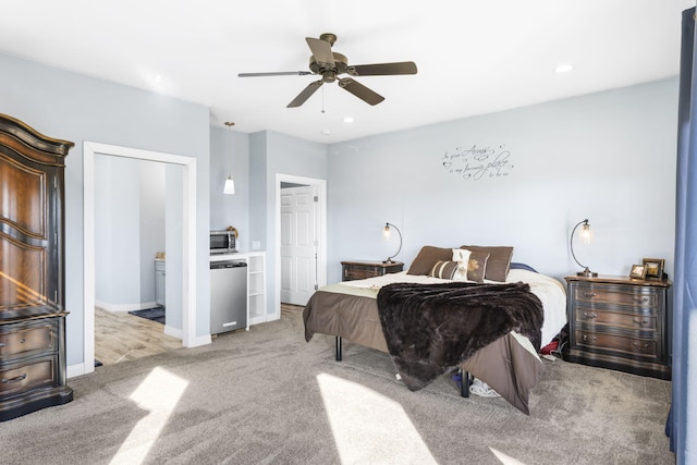 bedroom featuring ceiling fan, a closet, and light colored carpet