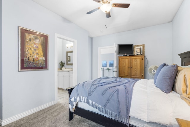 carpeted bedroom with ceiling fan and connected bathroom