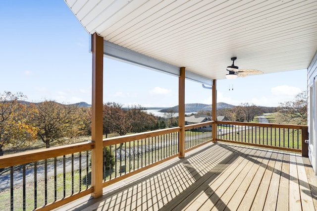 deck with ceiling fan and a water and mountain view