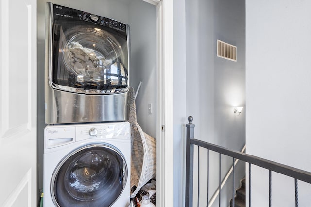 laundry area with stacked washer and clothes dryer