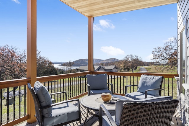 deck with a lawn and a mountain view