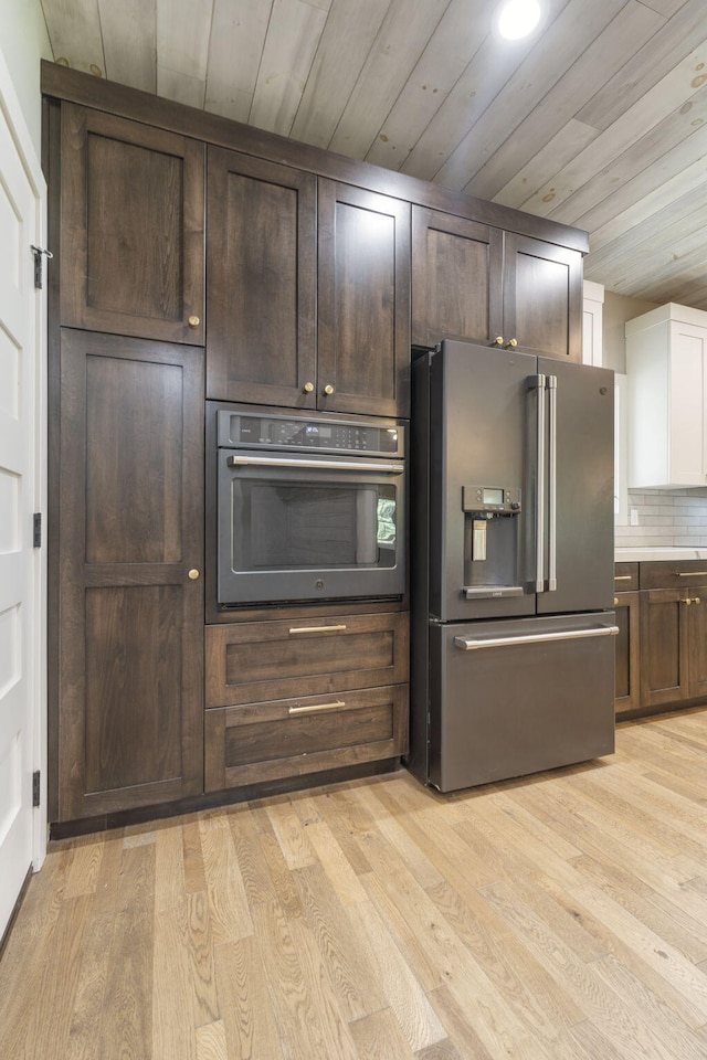 kitchen with light hardwood / wood-style floors, decorative backsplash, wooden ceiling, and stainless steel appliances