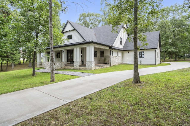 view of front of house featuring a front lawn and covered porch