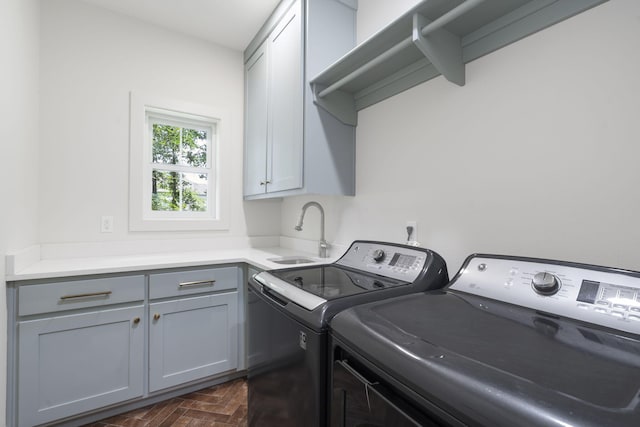 washroom with independent washer and dryer, cabinets, and sink