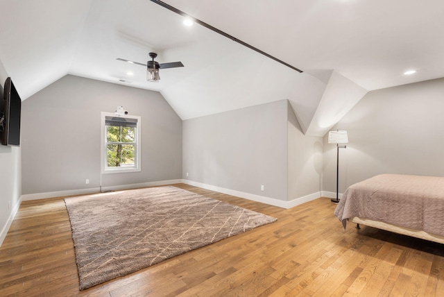 bedroom with vaulted ceiling, ceiling fan, and hardwood / wood-style floors