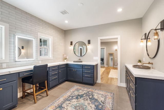 bathroom with tile patterned floors and vanity