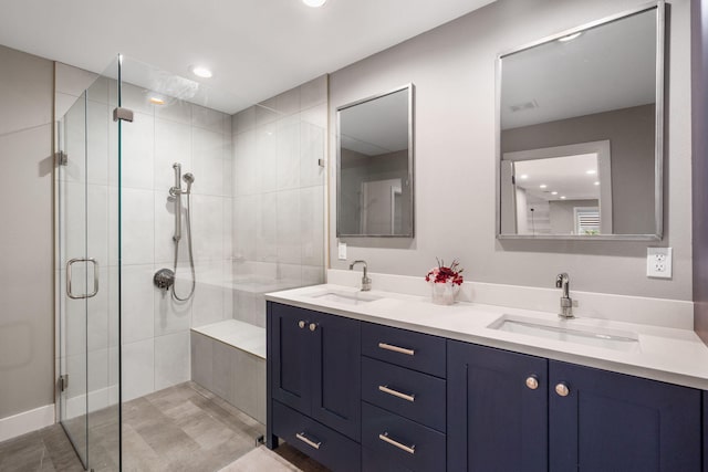 bathroom featuring walk in shower and vanity