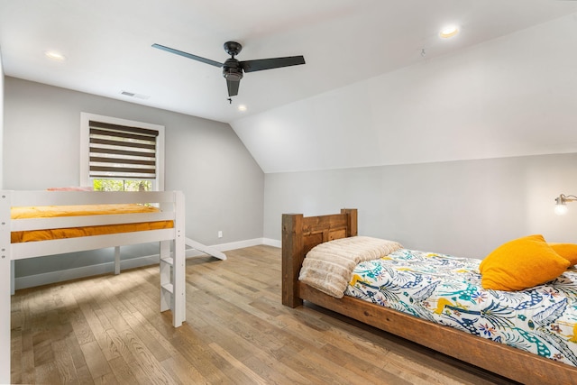 bedroom with wood-type flooring, vaulted ceiling, and ceiling fan