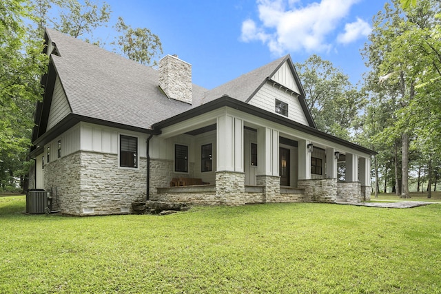 view of front of property with cooling unit, a porch, and a front lawn