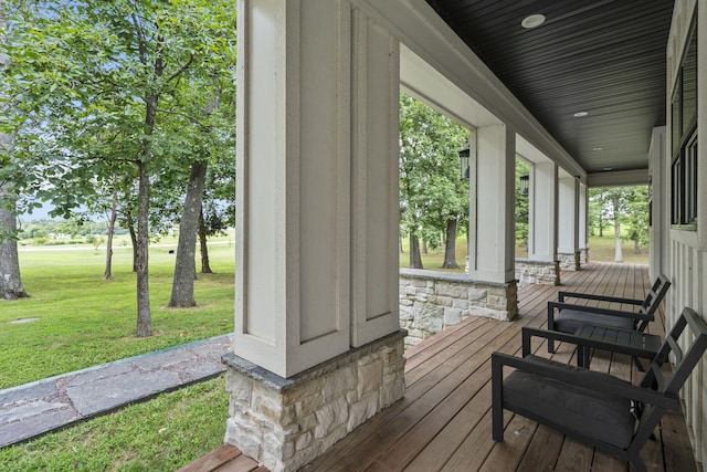 deck featuring a yard and a porch