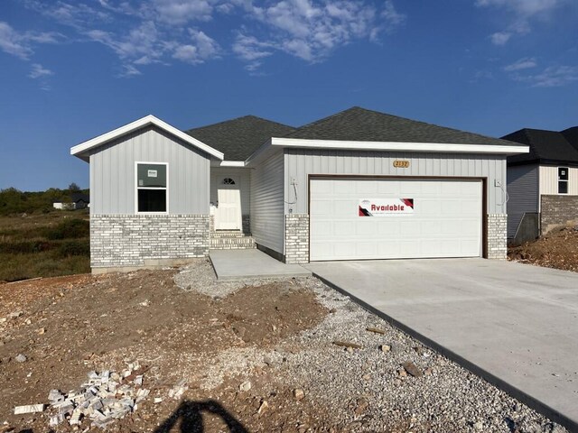 view of front of house featuring board and batten siding, driveway, and a garage